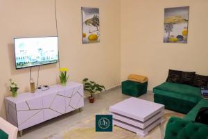 a living room with a tv and a couch at Executive 1BR with Free WiFi & Netflix in Nyeri