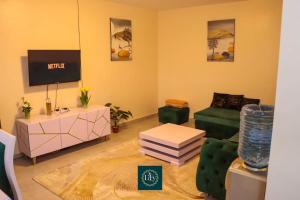 a living room with a couch and a tv at Executive 1BR with Free WiFi & Netflix in Nyeri