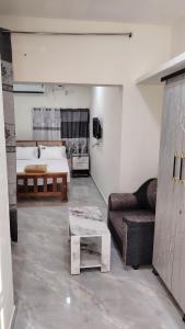 a living room with a couch and a table at Golden Stay Inn in Kovakulam