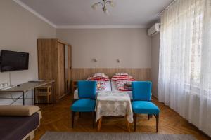 a room with a table and chairs and a bed at Mohacsi Guesthouse in Budapest