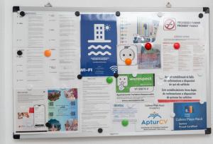 a whiteboard with a bunch of papers on it at Cullera Playa Racó in Cullera