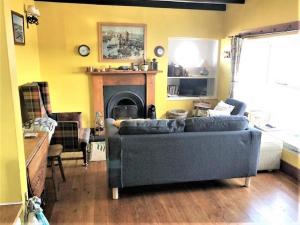 a living room with a couch and a fireplace at 2 Bed in Montrose oc-an48m in Johnshaven