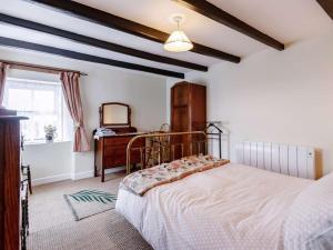 a bedroom with a bed and a dresser and a mirror at 2 Bed in Montrose oc-an48m in Johnshaven