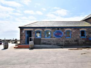 a brick building with a blue sign on it at 2 Bed in Montrose oc-an48m in Johnshaven