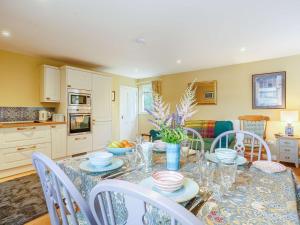 a dining room with a table and chairs and a kitchen at 1 Bed in Ardgay oc-89058 in Culrain +12 photos