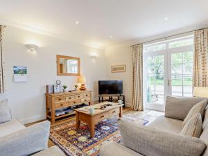 a living room with a couch and a tv at 3 Bed in Dingwall oc-ca388 in Cononbridge