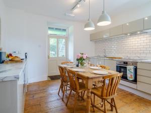 a kitchen with a wooden table and chairs at 3 Bed in Kendal oc-75564 in Crosthwaite +18 photos