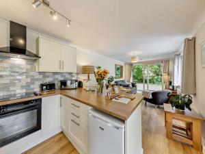 a kitchen with white cabinets and a counter top at 2 Bed in Crewe oc-83192 in Audlem
