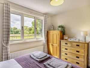 a bedroom with a bed and a window and a dresser at 2 Bed in Crewe oc-83192 in Audlem
