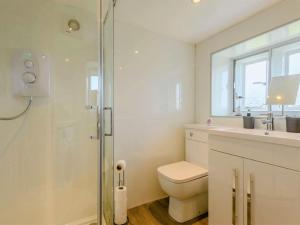 a bathroom with a toilet and a glass shower at 3 Bed in Penrith oc-89068 in Tirril +17 photos