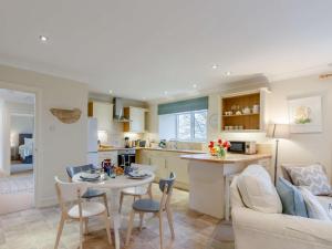 a kitchen and living room with a table and chairs at 2 Bed in Stirling oc-81513 in Doune +11 photos