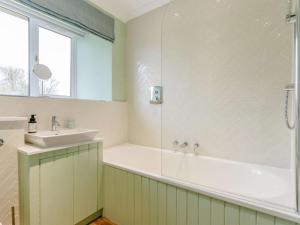 a bathroom with a tub and a sink at 2 Bed in Stirling oc-81513 in Doune