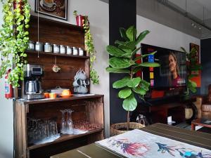a dining room with a table and a plant at Warm & Luxury Stay at Maboneng with Kingbed HugeTV WiFi in Johannesburg