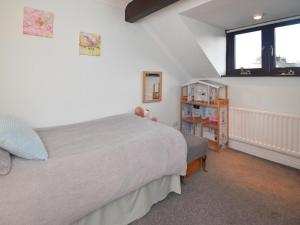 a bedroom with a large bed and a window at 3 Bed in Penrith oc-89268 in Newton Reigny