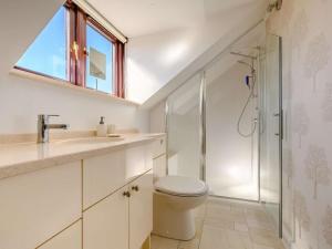 a bathroom with a toilet and a sink and a shower at 3 Bed in Penrith oc-89268 in Newton Reigny +23 photos