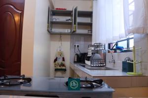 a kitchen with a sink and a counter top at Executive 1BR with Free WiFi & Netflix in Nyeri