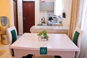 a white table with a plant on it in a kitchen at Executive 1BR with Free WiFi & Netflix in Nyeri +20 photos