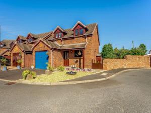 a large brick house with a blue garage at 3 Bed in Penrith oc-89268 in Newton Reigny