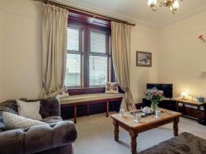 a living room with a couch and a window at 3 Bed in Buckie oc-89824 in Buckie