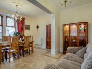 a living room with a couch and a dining room at 3 Bed in Buckie oc-89824 in Buckie