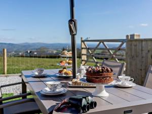 a table with a cake and other desserts on it at 2 Bed in Blackburn oc-finch in Blackburn