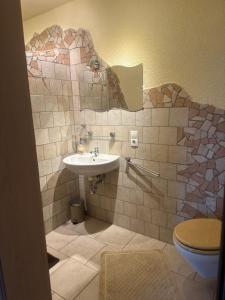 a bathroom with a sink and a toilet at Ferienwohnung am Nurburgring in Welcherath +11 photos