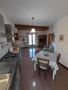 a kitchen and living room with a table and a stove at Terrazza sul cielo in Bella