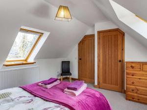 a bedroom with a bed with purple sheets and a window at 3 Bed in Huntly oc-57368 in Insch