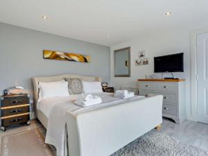 a bedroom with a white bed and a tv at 1 Bed in Crieff oc-58797 in Saint Fillans