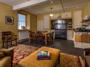 a kitchen and dining room with a table and chairs at 2 Bed in Grange Over Sands oc-lcc01 in Grange Over Sands
