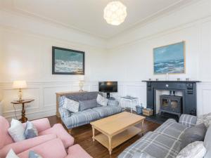 a living room with two couches and a fireplace at 4 Bed in Eyemouth oc-ca256 in Coldingham