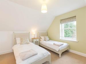 a bedroom with two beds and a window at 4 Bed in Eyemouth oc-ca256 in Coldingham