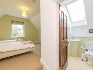 a bathroom with a bed and a sink and a window at 4 Bed in Eyemouth oc-ca256 in Coldingham +16 photos