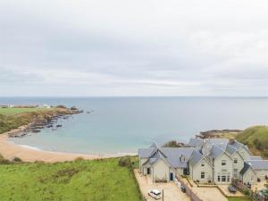 an aerial view of a house and the beach at 4 Bed in Eyemouth oc-ca256 in Coldingham