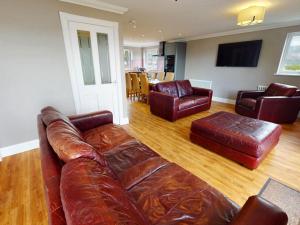 a living room with a leather couch and chairs at 3 Bed in Onich oc-ca159 in Onich