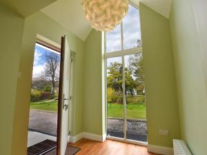 a room with a large window and a chandelier at 3 Bed in Onich oc-ca159 in Onich