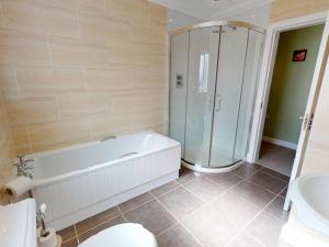 a bathroom with a tub and a shower and a toilet at 3 Bed in Onich oc-ca159 in Onich +16 photos