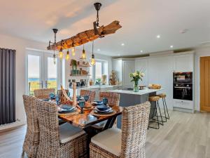a kitchen and dining room with a table and chairs at 4 Bed in Wick oc-95612 in Huna