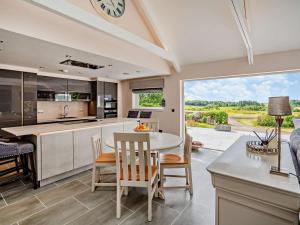 a kitchen with a table and chairs and a clock at 1 Bed in Glasgow oc-83392 in Eaglesham
