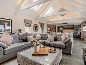 a living room with a couch and a table at 1 Bed in Glasgow oc-83392 in Eaglesham +14 photos