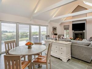 a kitchen and living room with a table and chairs at 1 Bed in Glasgow oc-83392 in Eaglesham