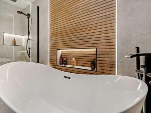 a white bath tub in a bathroom with a fireplace at 1 Bed in Glasgow oc-83392 in Eaglesham