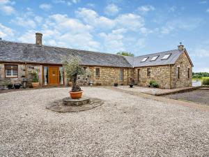 an old stone house with a courtyard in front of it at 1 Bed in Glasgow oc-83392 in Eaglesham