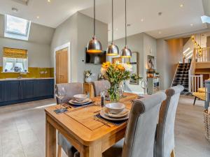 a kitchen and dining room with a wooden table at 2 Bed in Auchterarder oc-94546 in Auchterarder