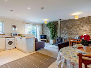 a kitchen and living room with a table and a living room at 1 Bed in Beauly oc-82779 in Beauly