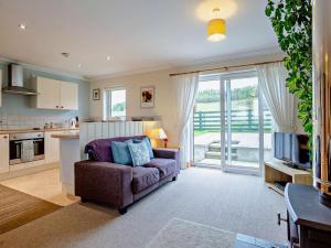 a living room with a couch and a kitchen at 1 Bed in Beauly oc-82779 in Beauly