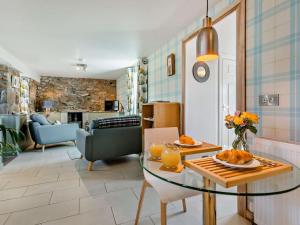 a living room with a table and a dining room at 1 Bed in Forres oc-32129 in Burghead