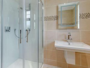 a bathroom with a shower and a sink and a mirror at 2 Bed in Fort William oc-83310 in Onich