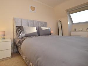 a bedroom with a large bed with a large window at 3 Bed in Galashiels oc-76698 in Galashiels