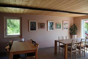 a dining room with a wooden table and chairs at Ferienwohnung Obstgarten in Märstetten